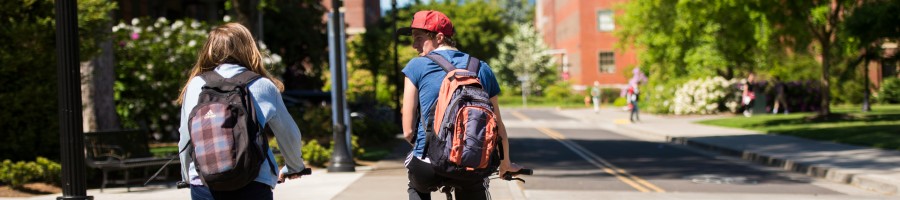Two people biking across campus