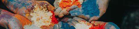 Hands holding powdered colors