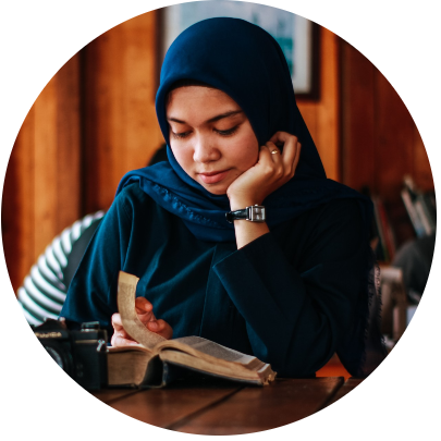 Woman studying from textbooks in cafe